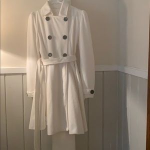 White pea coat with black buttons.